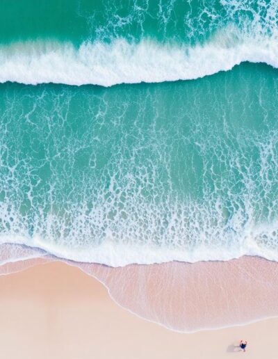 Аerial view of turquoise ocean waves on sandy beach — Elias Thorne Photography